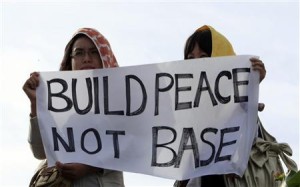 Protesters hold a sign at a mass anti-U.S. base rally in Ginowan on Japan's southwestern island of Okinawa