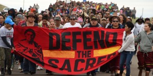 Native Americans march to the site of a sacred burial ground that was disturbed by bulldozers building the Dakota Access Pipeline (DAPL), near the encampment where hundreds of people have gathered to join the Standing Rock Sioux Tribe's protest of the oil pipeline slated to cross the nearby Missouri River, September 4, 2016 near Cannon Ball, North Dakota.   Protestors were attacked by dogs and sprayed with an eye and respiratory irritant yesterday when they arrived at the site to protest after learning of the bulldozing work. / AFP / ROBYN BECK        (Photo credit should read ROBYN BECK/AFP/Getty Images)